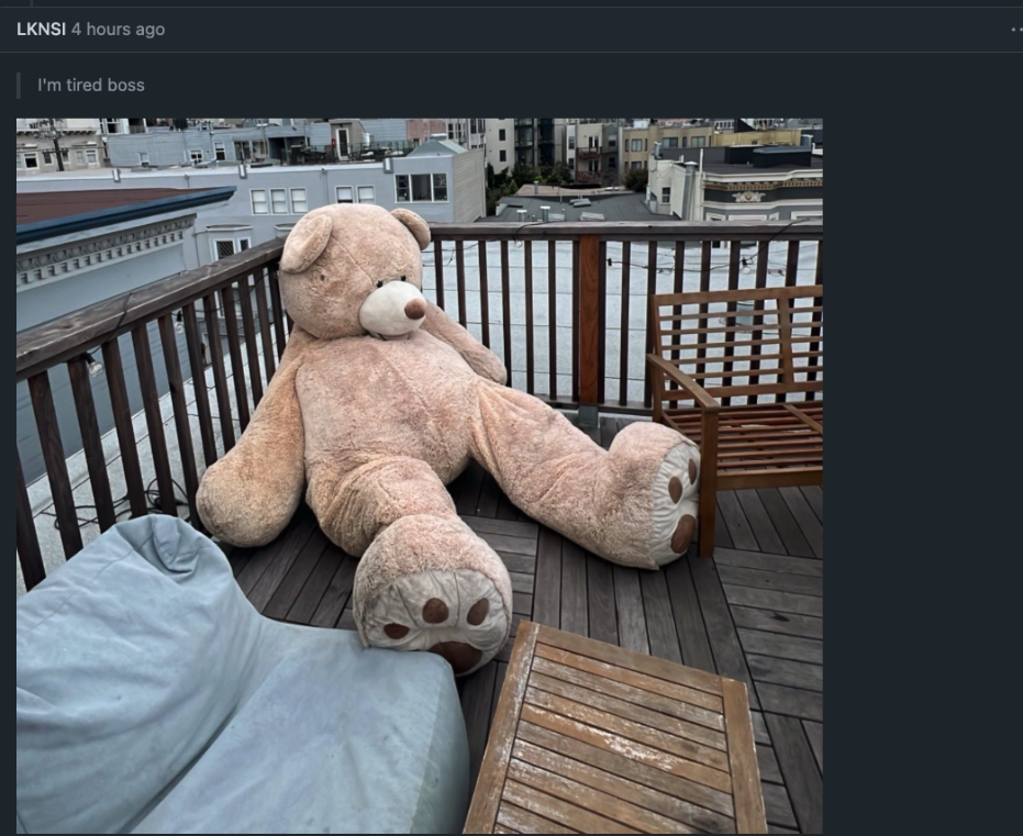 Screenshot of a GitHub discussion comment by user LKNSI posted 4 hours ago, containing a photo of a very large stuffed teddy bear sitting on a balcony, with the caption "I'm tired boss." The comment received 113 reactions, expressing community exhaustion following the axios supply chain compromise disclosure.